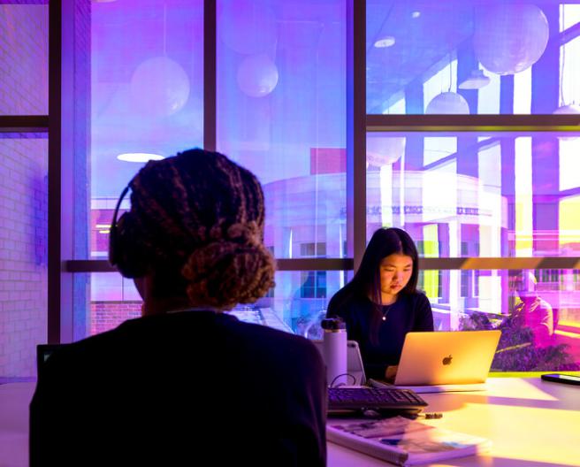 students at laptop, purple background